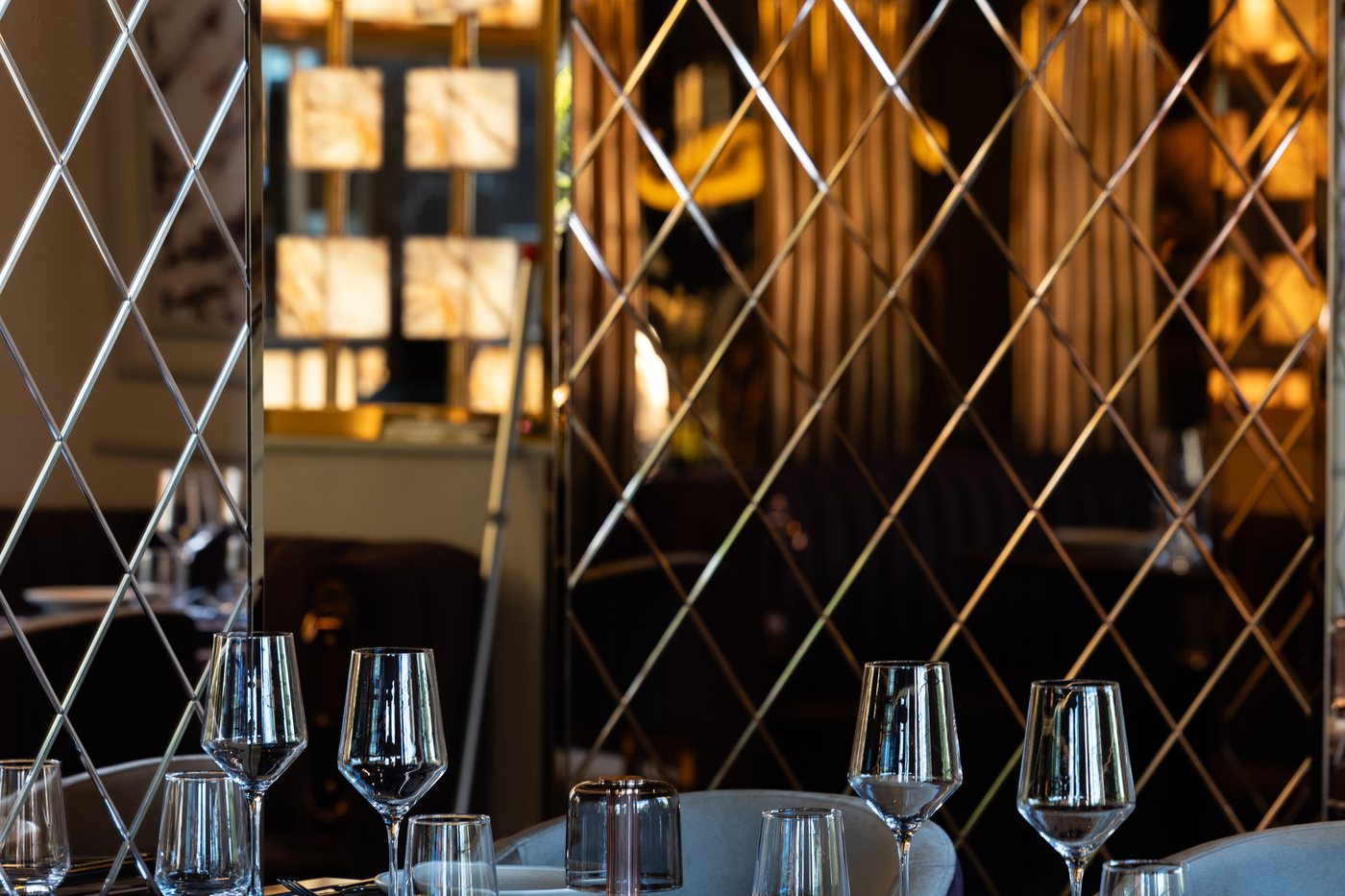Glassware set against the brass lattice of the lounge